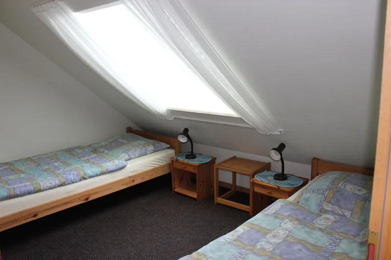 Zweites Kinderzimmer mit zwei Einzelbetten unter der Dachschräge